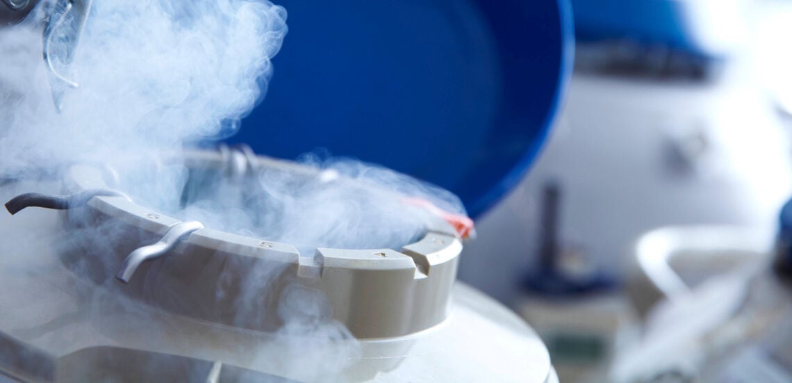 Close-up of a cryogenic storage tank with vapour, used for preserving donor sperm, eggs, or embryos in fertility treatments.