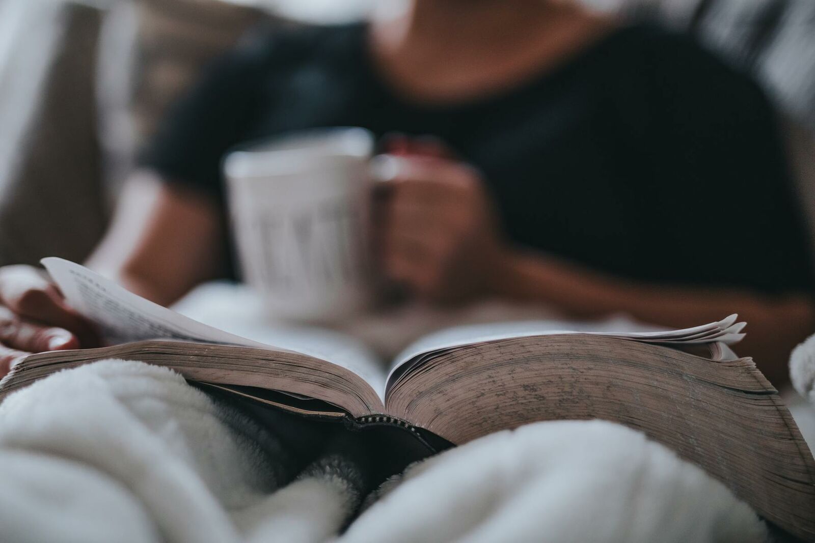 Relaxed woman reading trying to incorporate some relaxation techniques for her IVF treatment.