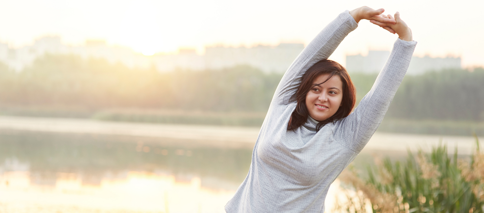 A women stretching outside, highlighting the connection between BMI and healthy conception